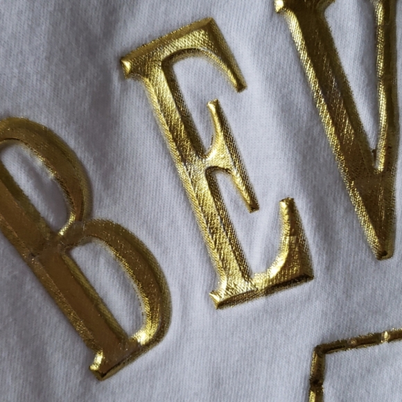 Donated white t shirt with gold puffy letters. XL - Picture 3 of 4